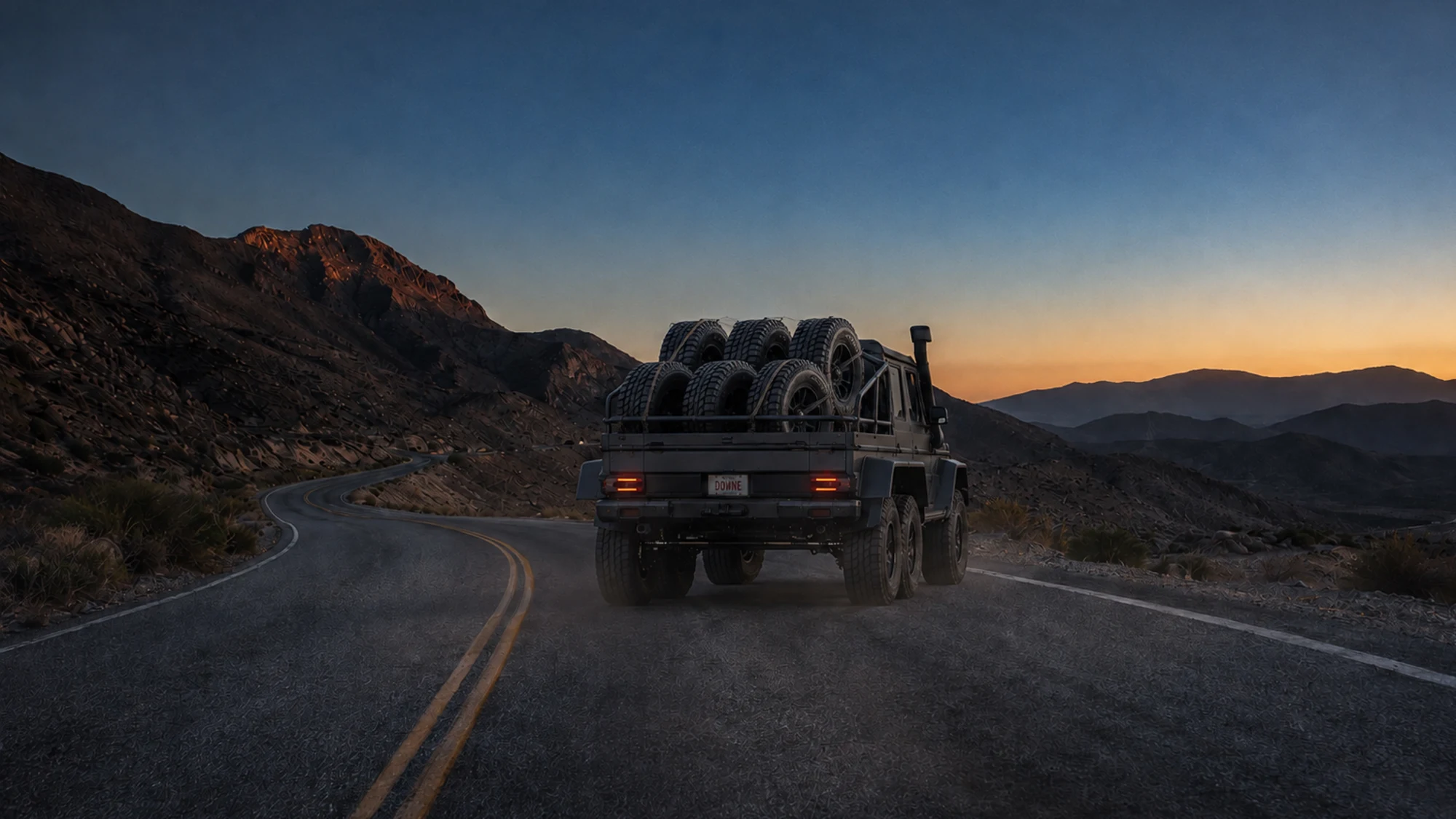 The six-wheel Brabus G-Wagon at sunset with the DOWNE license plate.